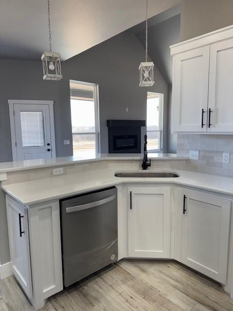 kitchen featuring sink, white cabinetry, and dishwasher