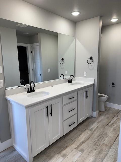 bathroom featuring hardwood / wood-style floors, toilet, and vanity