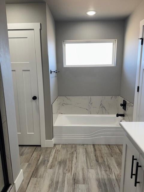 bathroom with plenty of natural light, hardwood / wood-style flooring, and vanity