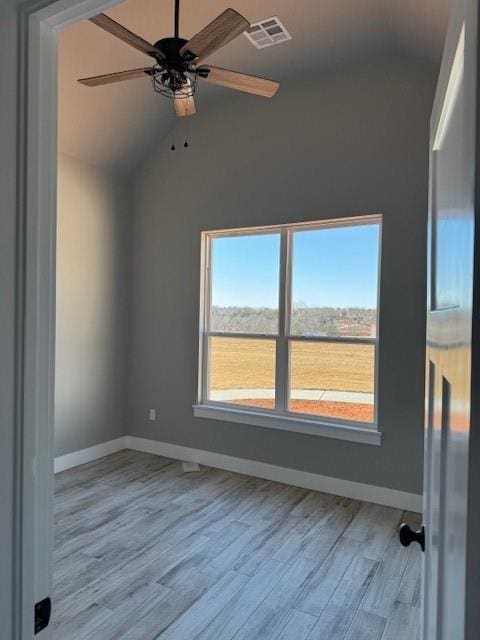 spare room with ceiling fan, light hardwood / wood-style flooring, and lofted ceiling