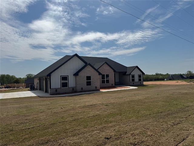 view of front of house featuring a garage, board and batten siding, driveway, and a front lawn