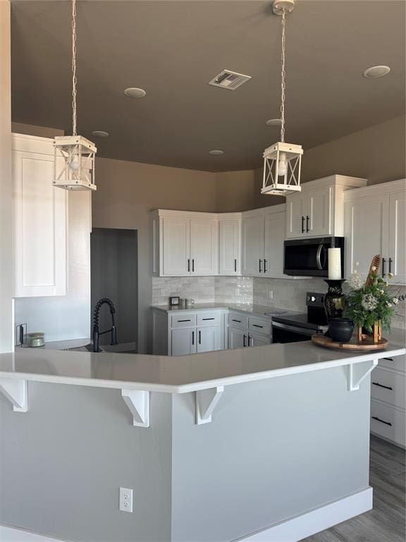 kitchen with stainless steel electric range oven, backsplash, visible vents, and light countertops