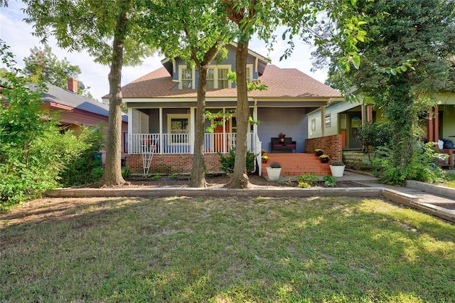 view of front of home with a front lawn and covered porch