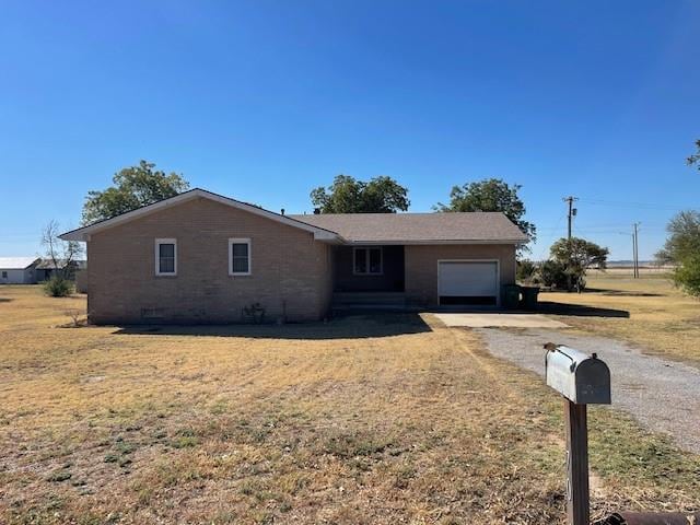 single story home with a garage and a front lawn