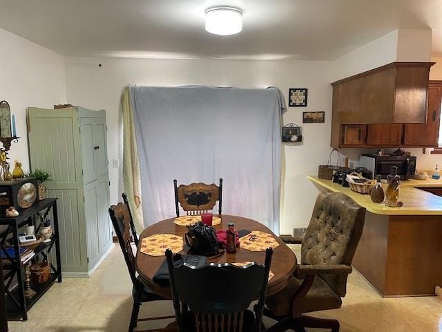 dining space with light colored carpet