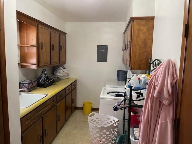 laundry room with cabinets, electric panel, washer and dryer, and sink