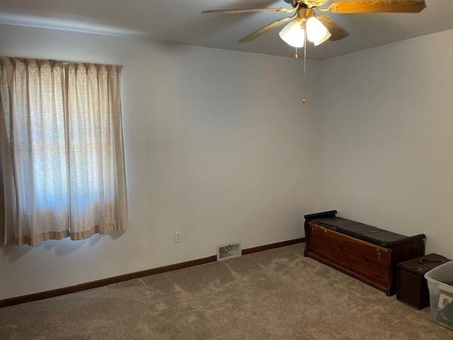 unfurnished room featuring light carpet and ceiling fan