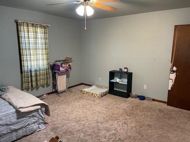 carpeted bedroom featuring ceiling fan