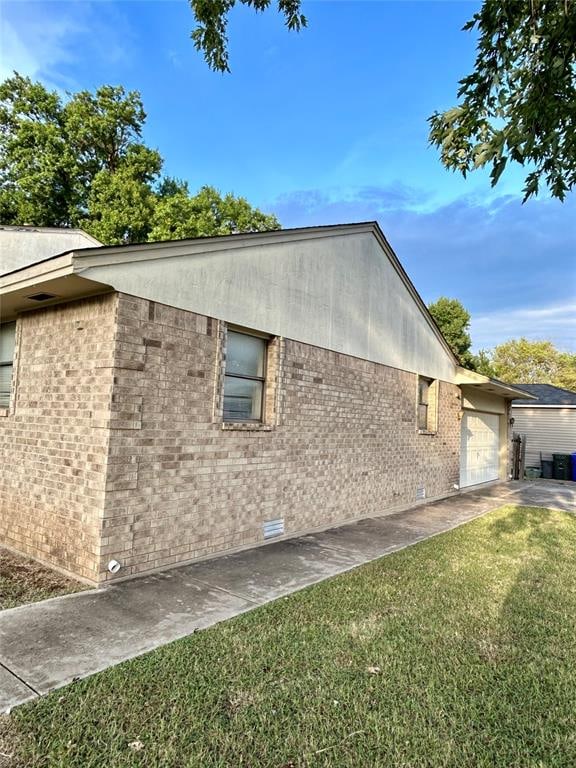 view of home's exterior with a yard and a garage