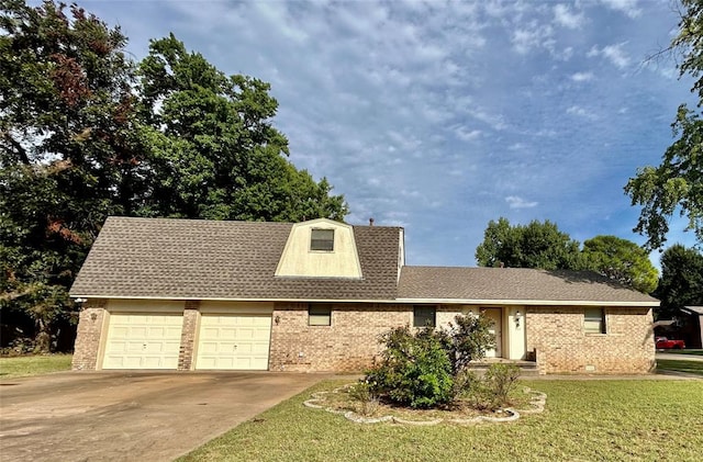 view of front of home featuring a garage and a front lawn