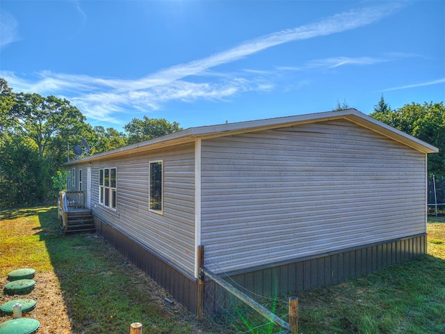 view of property exterior with a yard