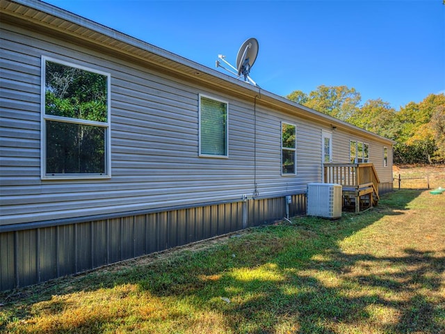 view of home's exterior featuring a yard and cooling unit