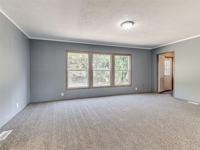 unfurnished room featuring carpet, a textured ceiling, and ornamental molding