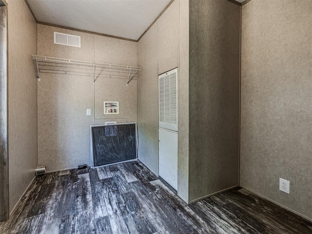 laundry area featuring a textured ceiling, crown molding, washer hookup, and dark hardwood / wood-style floors