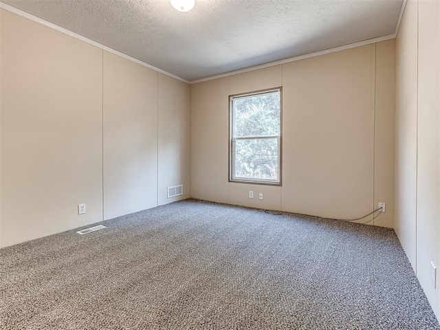 unfurnished room featuring carpet flooring, ornamental molding, and a textured ceiling