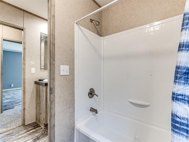 bathroom featuring hardwood / wood-style flooring and tiled shower / bath