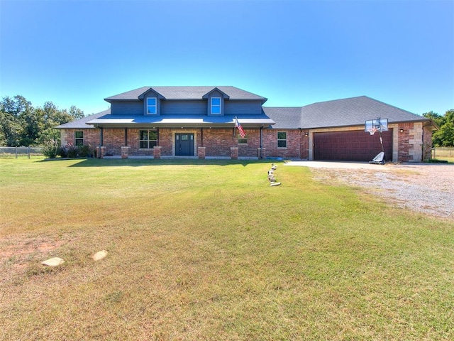 view of front of home with a front yard and a garage