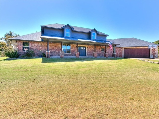 view of front of property with a front yard and a garage