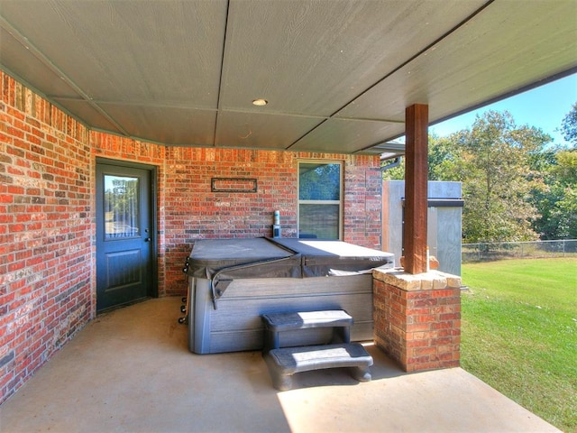 view of patio / terrace with a hot tub