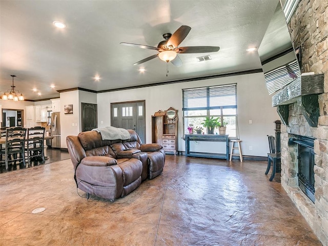 living room featuring ceiling fan, a fireplace, and crown molding