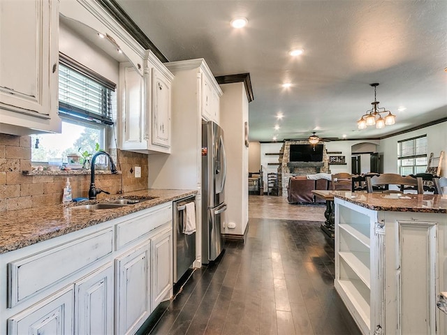 kitchen featuring white cabinetry, sink, stainless steel appliances, light stone counters, and dark hardwood / wood-style flooring