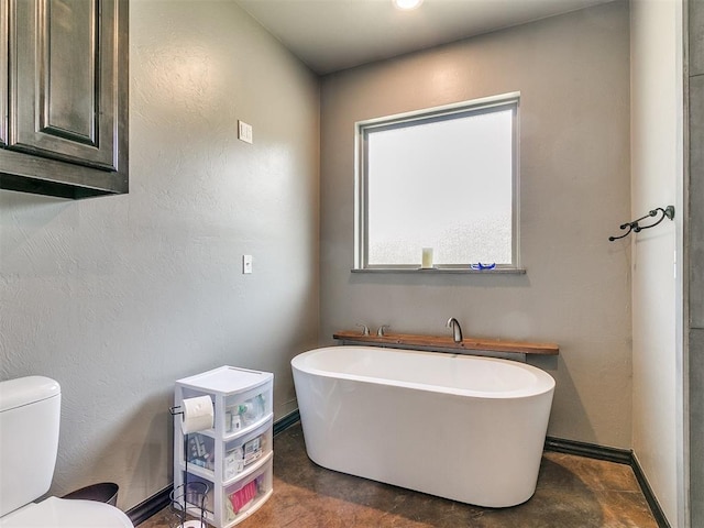 bathroom featuring a bath and toilet