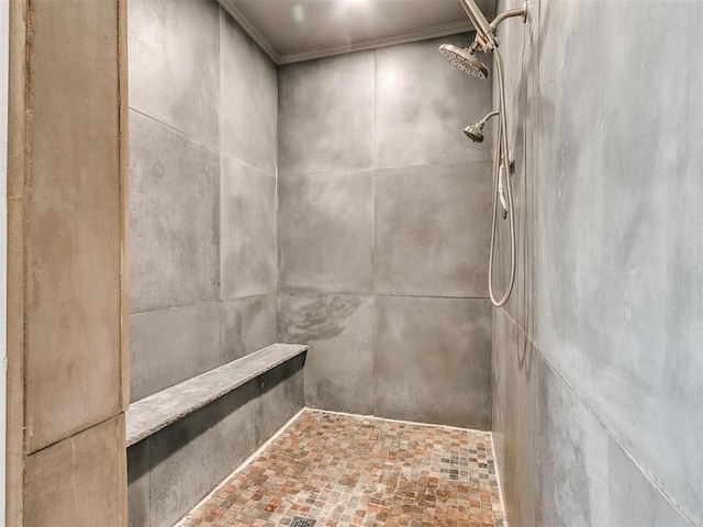 interior details featuring a tile shower and ornamental molding