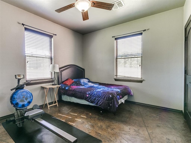 bedroom with ceiling fan and multiple windows