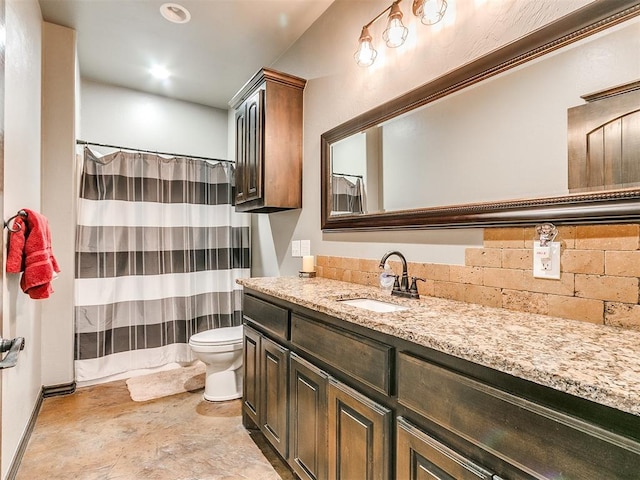 bathroom with curtained shower, vanity, and toilet