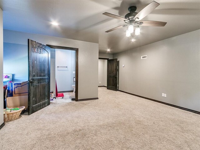 interior space with light carpet and ceiling fan