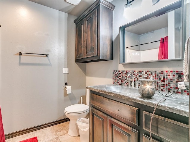 bathroom featuring tile patterned floors, a shower, toilet, decorative backsplash, and vanity