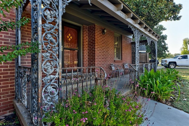 view of side of property featuring covered porch