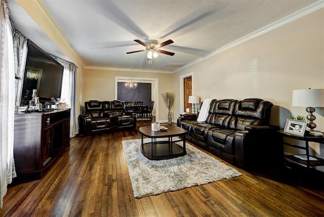 living room featuring dark hardwood / wood-style floors, ornamental molding, and ceiling fan with notable chandelier