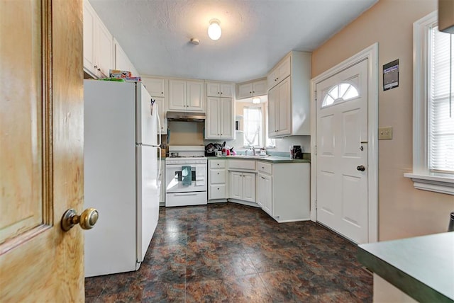 kitchen with white appliances and white cabinetry