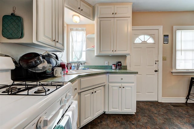 kitchen featuring sink, white cabinets, and a healthy amount of sunlight