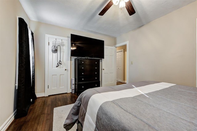 bedroom with ceiling fan and dark wood-type flooring