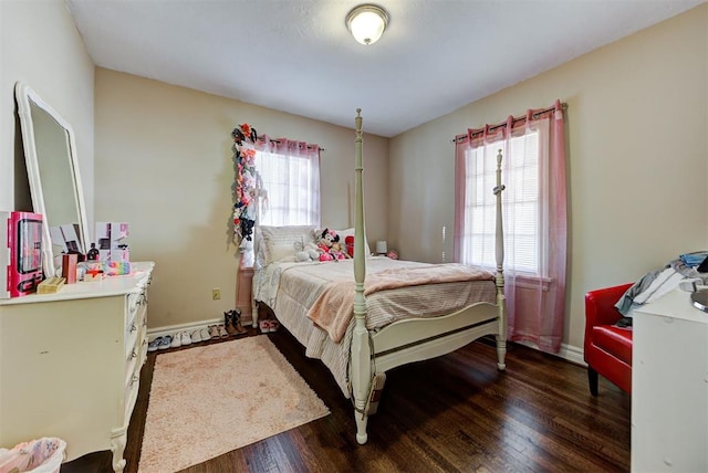 bedroom featuring dark hardwood / wood-style floors and multiple windows