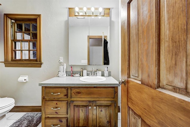 bathroom with vanity and toilet