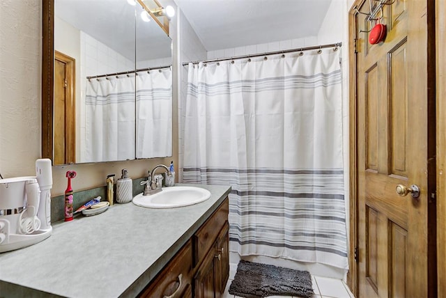 bathroom with tile patterned flooring and vanity