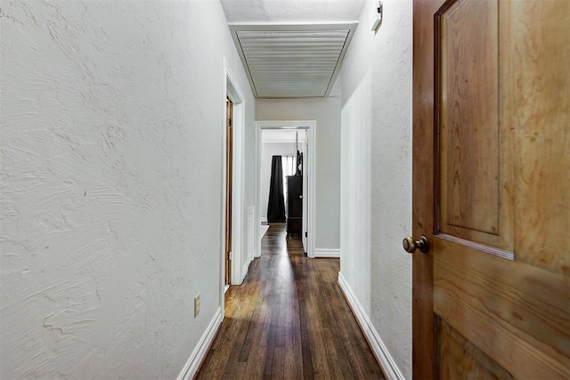 hallway with dark hardwood / wood-style flooring