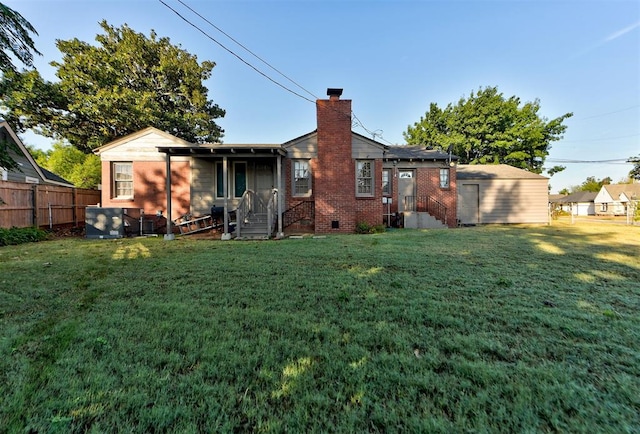 rear view of property with a lawn