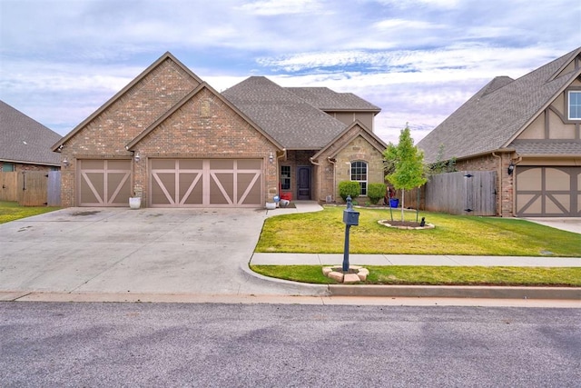 view of front of home featuring a front yard and a garage