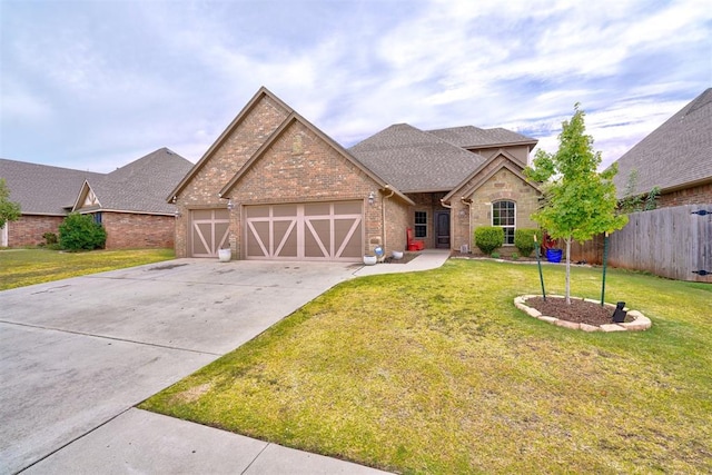 view of front of property with a garage and a front lawn