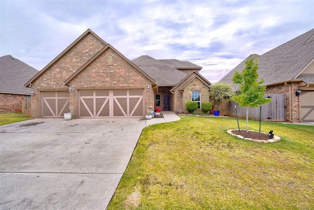 view of front of home with a garage and a front yard