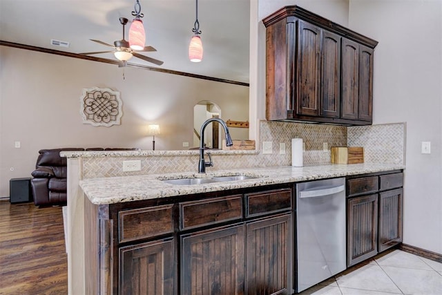 kitchen featuring dark brown cabinetry, crown molding, sink, and stainless steel dishwasher