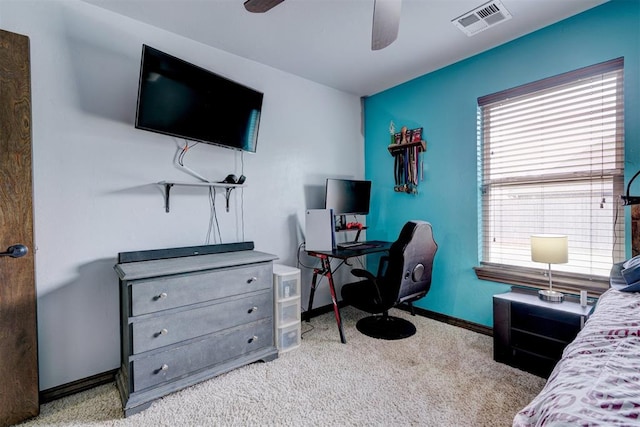 carpeted bedroom with multiple windows and ceiling fan