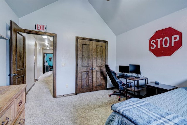 bedroom with light carpet and high vaulted ceiling