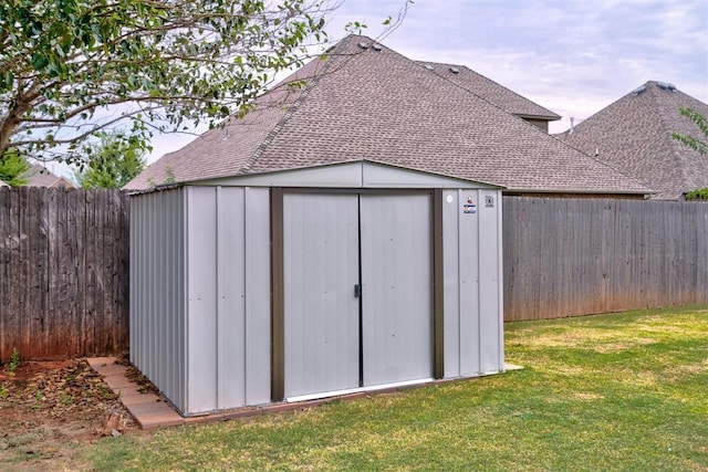 view of outbuilding featuring a lawn