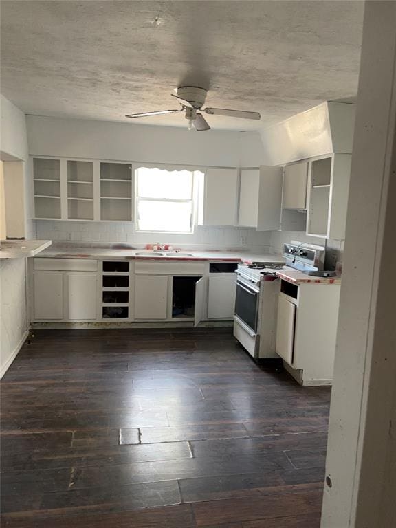 kitchen featuring white range oven, ceiling fan, white cabinets, and dark wood-type flooring