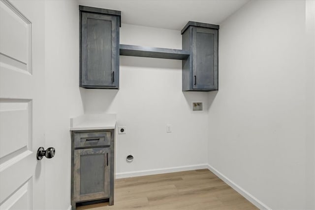 laundry area featuring washer hookup, hookup for an electric dryer, cabinets, and light wood-type flooring